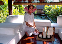 Massage therapist in conical hat waits for clients in Ana Mandara Resort, Vietnam. © ADAMS / HANSEN STOCK PHOTOS