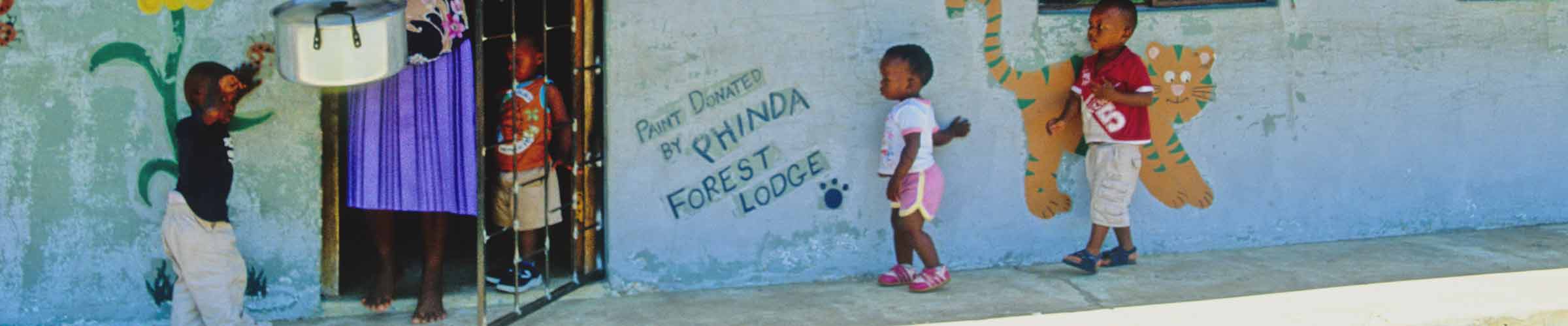 Outside an African shop with small children